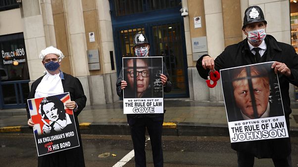 Anti-Brexit protesters hold signs as Michael Gove leaves the third meeting of the EU-UK Joint Committee in Brussels Anti-Brexit protesters hold signs as Michael Gove leaves the third meeting of the EU-UK Joint Committee in Brussels