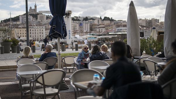 People enjoy refreshments at a restaurant, in Marseille People enjoy refreshments at a restaurant, in Marseille