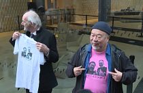John Shipton and Ai Weiwei showing T-shirts reading 'Free Assange'