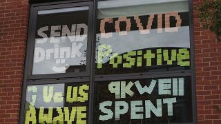 Signs posted on a window at Manchester Metropolitan University's Birley campus.