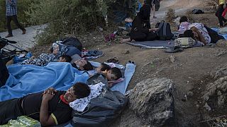 Migrants sleep outside the burned Moria refugee camp, on the northeastern Aegean island of Lesbos, Greece, on Wednesday, Sept. 9, 2020. 