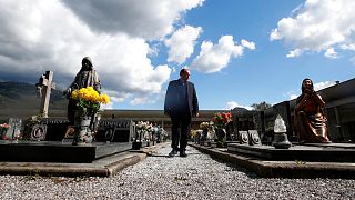 Rev. Mario Carminati walks in a cemetery in Casnigo, near Bergamo, Italy, Sunday, Sept. 27, 2020. 