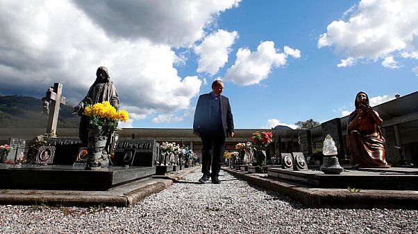 Rev. Mario Carminati walks in a cemetery in Casnigo, near Bergamo, Italy, Sunday, Sept. 27, 2020. Rev. Mario Carminati walks in a cemetery in Casnigo, near Bergamo, Italy, Sunday, Sept. 27, 2020.