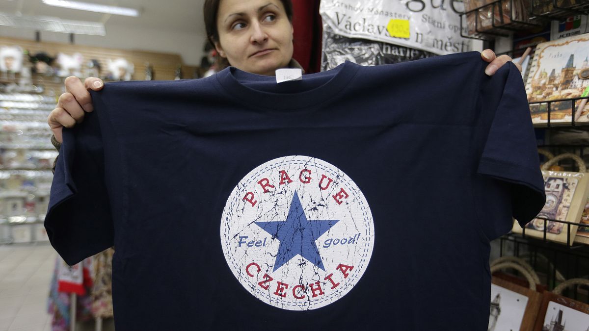 A vendor displays a t-shirt with the word "Czechia" in a store in Prague, Czech Republic, Thursday, April 14, 2016. 