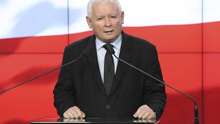 The leader of the Polish ruling party, Jaroslaw Kaczynski,center, speaks to reporters in Warsaw, Poland, Saturday, Sept. 26, 2020.