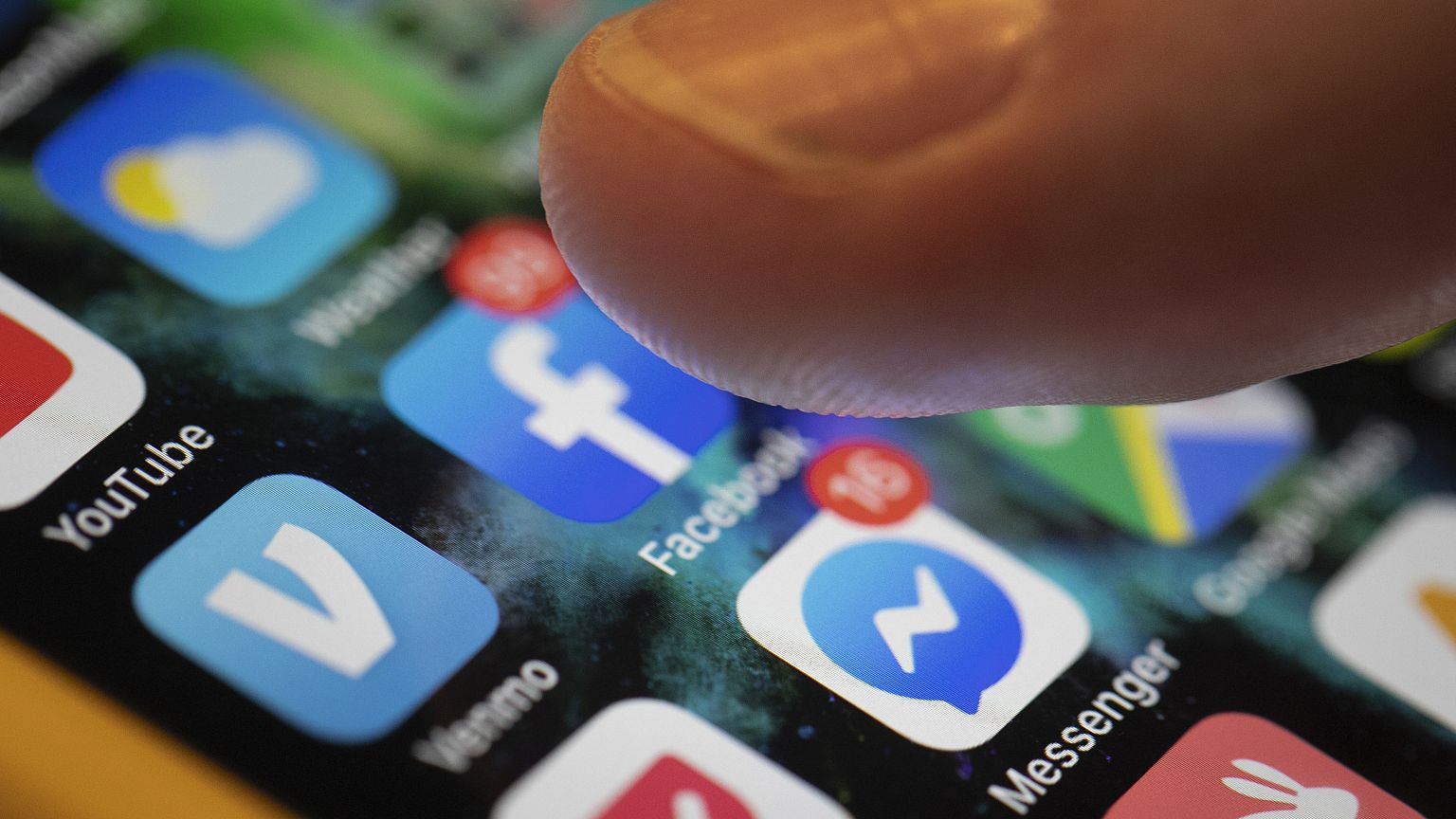 In this Aug. 11, 2019, file photo an iPhone displays the apps for Facebook and Messenger.