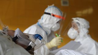 Healthcare workers attend to a COVID-19 patient in an intensive care unit (ICU) at Na Bulovce hospital in Prague, Czech Republic