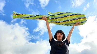 Ella Daish holds her giant 1.8m tampon applicator made from period plastic. Ella Daish holds her giant 1.8m tampon applicator made from period plastic.