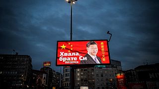 A picture taken on March 30, 2020, shows a billboard bearing Chinese President Xi Jinping's face looking down over a boulevard next to the words "Thank you brother Xi"