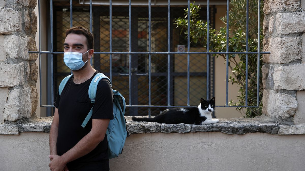 Actor and theater director Aris Laskos poses outside the Theater of Neos Kosmos in Athens, Thursday, Oct. 1, 2020. 