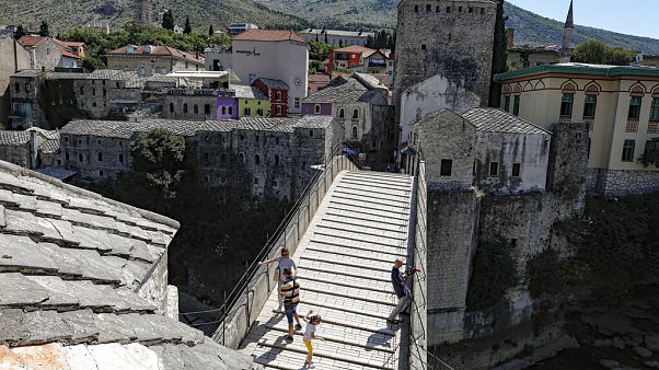 The Old Bridge in Mostar, one of Bosnia's best known landmarks, usually bustling with tourists this time of the year, is all but deserted, Thursday, July 2, 2020. The Old Bridge in Mostar, one of Bosnia's best known landmarks, usually bustling with tourists this time of the year, is all but deserted, Thursday, July 2, 2020.