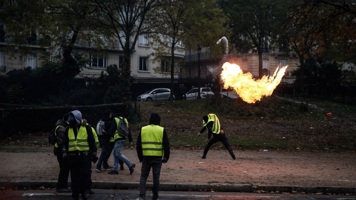 FILE - A protester throws a molotov cocktail during a "Yellow Vest" protest on December 1, 2018 in Paris.