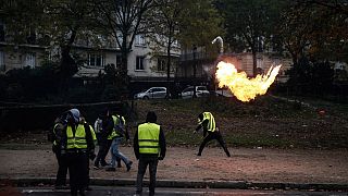 FILE - A protester throws a molotov cocktail during a "Yellow Vest" protest on December 1, 2018 in Paris.