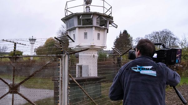 A cameraman films a control tower of the former GDR border guard forces in Moedlareuth prior to the 30th anniversary of the falling of the Berlin wall A cameraman films a control tower of the former GDR border guard forces in Moedlareuth prior to the 30th anniversary of the falling of the Berlin wall