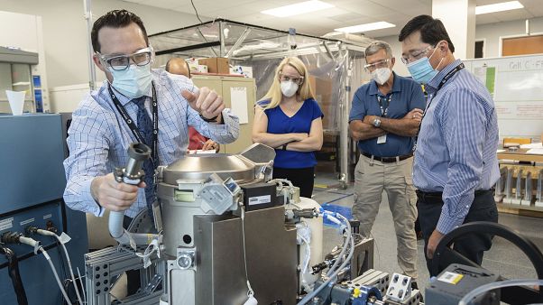 In this June 18, 2020 photo provided by NASA, astronaut Kate Rubins, center, and support personnel review the Universal Waste Management System, a low-gravity space toilet. In this June 18, 2020 photo provided by NASA, astronaut Kate Rubins, center, and support personnel review the Universal Waste Management System, a low-gravity space toilet.