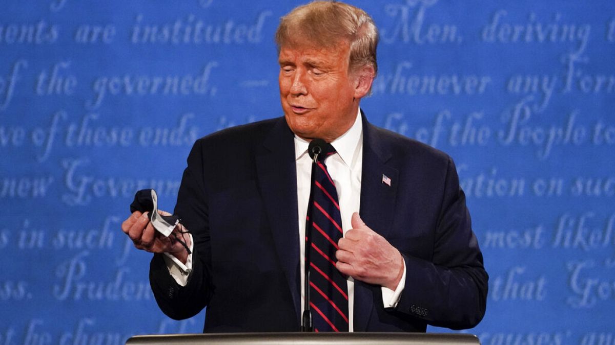 US President Donald Trump holds up a mask at the first presidential debate days before testing positive for COVID-19.