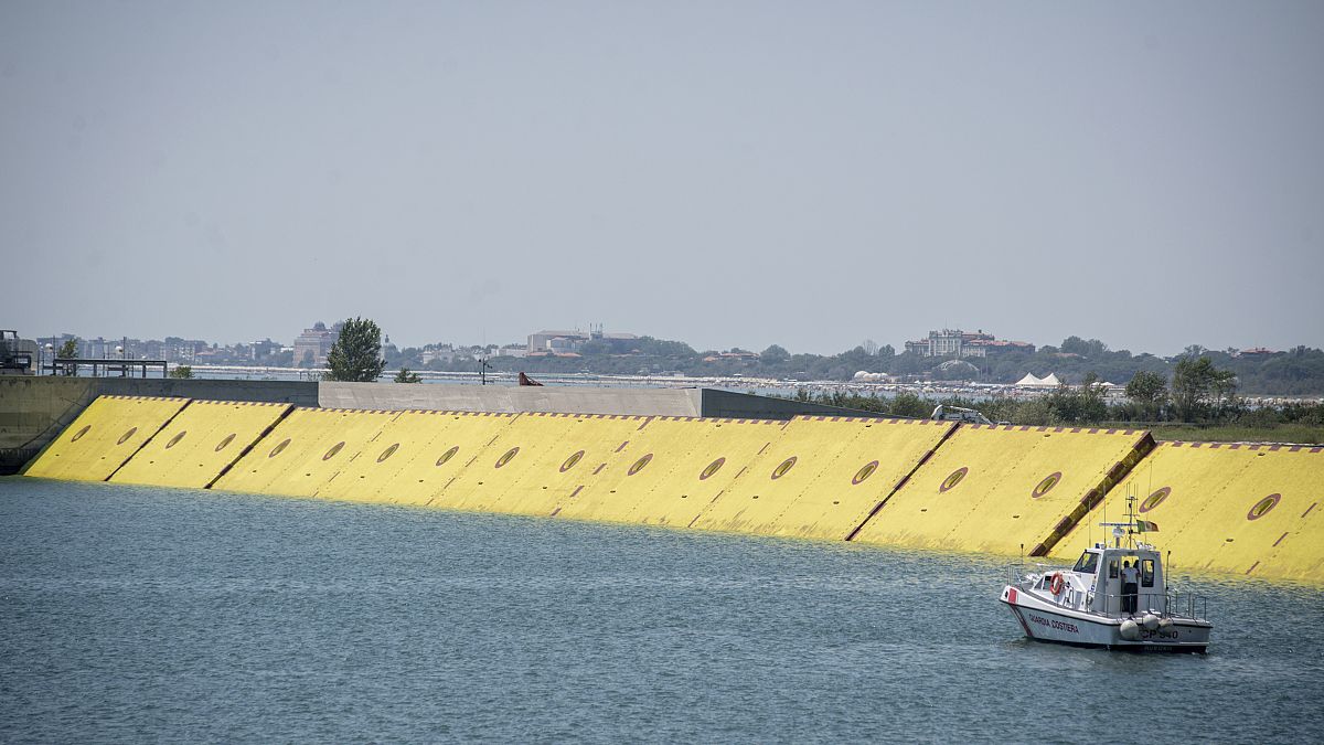 Moveable flood gates rise from the sea in the Venice lagoon, Italy, Friday, July 10, 2020. 