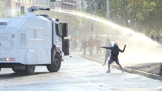 Police fire water cannons at protesters