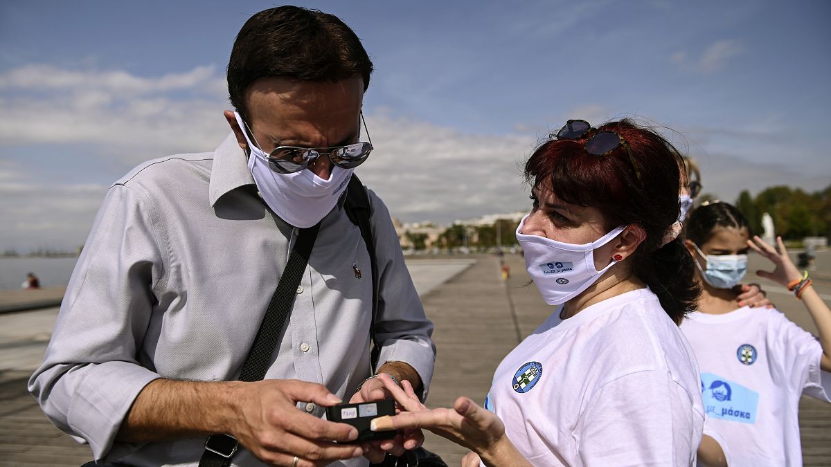 A participant has her oxygen saturation measured, during an event organized by the local medical association, in order to support the use of protective masks, in Greece.