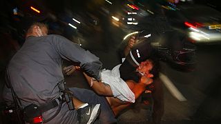 Israeli police officers arrest an Israeli protester during a demonstration against lockdown measures that they believe are aimed at curbing protests against Benjamin Netanyahu