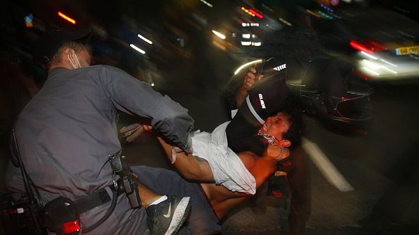 Israeli police officers arrest an Israeli protester during a demonstration against lockdown measures that they believe are aimed at curbing protests against Benjamin Netanyahu Israeli police officers arrest an Israeli protester during a demonstration against lockdown measures that they believe are aimed at curbing protests against Benjamin Netanyahu