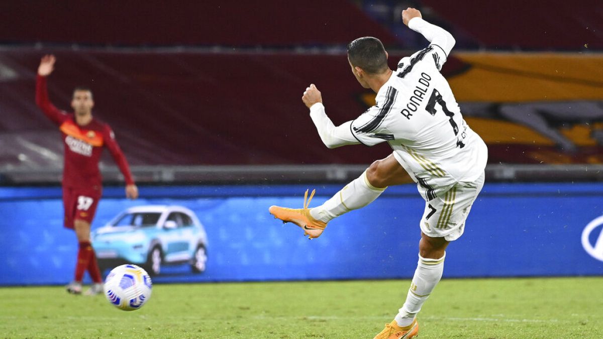 Juventus' Cristiano Ronaldo, right, takes a shot during the Italian Serie A match between Roma and Juventus at Rome's Olympic stadium, Sunday, Sept. 27, 2020. 