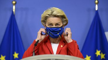 FIle photo: EU Commission President Ursula von der Leyen takes off her protective mask prior to making a statement in Brussels. Oct. 1, 2020.