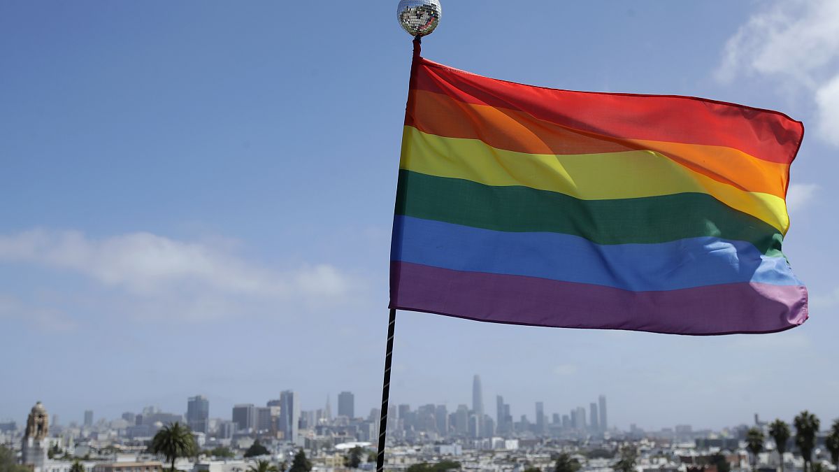 A rainbow flag flies over the skyline at Dolores Park in San Francisco, June 28, 2020.
