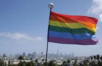 A rainbow flag flies over the skyline at Dolores Park in San Francisco, June 28, 2020.
