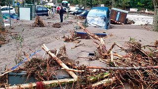 A man stands in the middle of a flooded street in Breil-sur-Roya, near the border with Italy, Saturday Oct. 3, 2020.