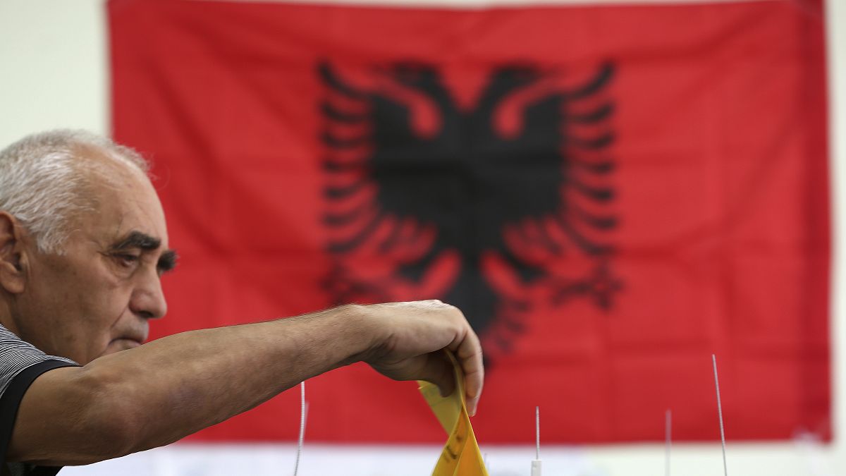 A man casts his ballot at a polling station in Tirana, Sunday, June 30, 2019.
