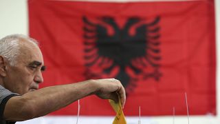 A man casts his ballot at a polling station in Tirana, Sunday, June 30, 2019.