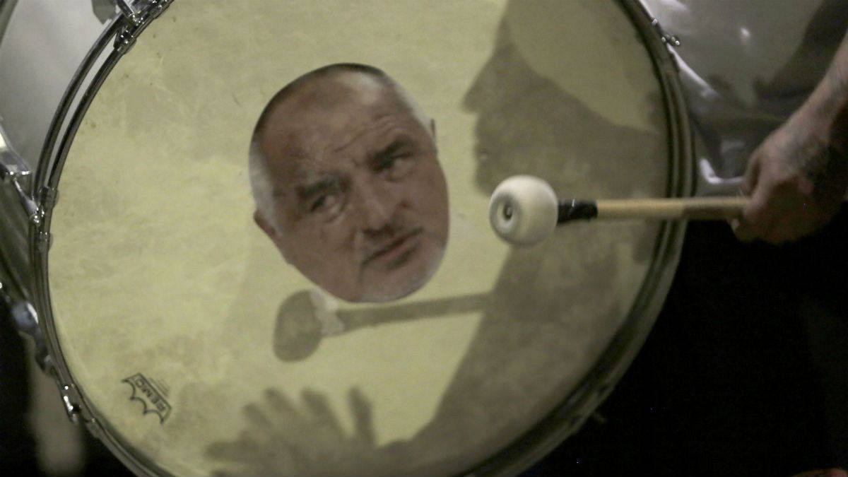 A protester beats a drum showing a portrait of Bulgarian Prime Minister Boyko Borissov during an anti-government protest in front of the new National Assembly building, in Sof