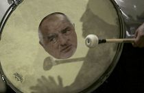 A protester beats a drum showing a portrait of Bulgarian Prime Minister Boyko Borissov during an anti-government protest in front of the new National Assembly building, in Sof
