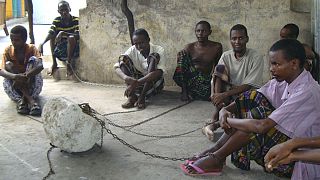 In this photo of Wednesday April 28, 2011, chained mentally ill patients sit within Ahlu Khayr mental health center in Mogaidshu, Somalia. Somalia may be the worst place on ea