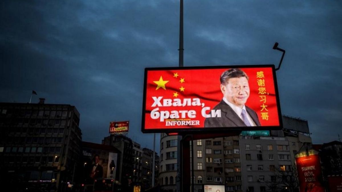 A picture taken on March 30, 2020, shows a billboard bearing Chinese President Xi Jinping's face looking down over a boulevard next to the words "Thank you brother Xi" 