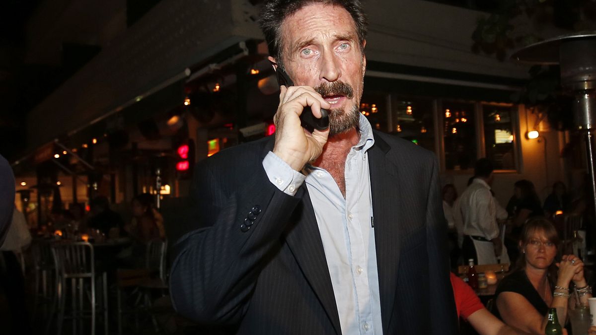 John McAfee pictured in 2012 on his mobile phone in the South Beach area of Miami.