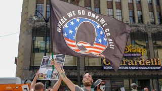 Demonstrators from conspiracy theorist group QAnon protest in Los Angeles in August.