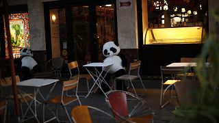 Panda bear cuddly toys rest in an empty terrace of a restaurant in downtown Brussels, Saturday, Oct. 3, 2020. 