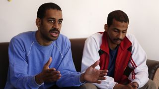 Alexanda Amon Kotey, left, and El Shafee Elsheikh speak during an interview with The Associated Press at a security centre in Kobani, Syria. in March 2019.