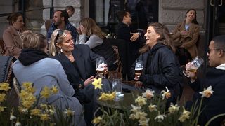 File photo: People chat and drink outside a bar in Stockholm, Sweden, while elsewhere in Europe, citizens were locked down. April 8, 2020.