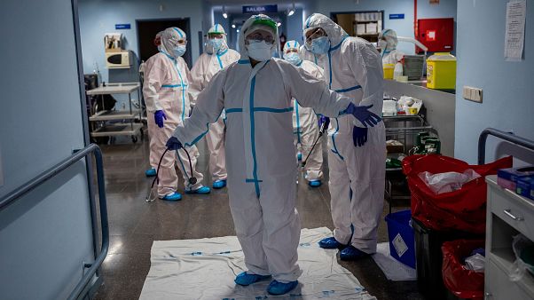 A medical team member is disinfected on the COVID-19 ward at a hospital in Leganes, near Madrid