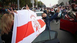 People march during an opposition rally to protest the official presidential election results in Minsk, Belarus, Oct. 4, 2020. 