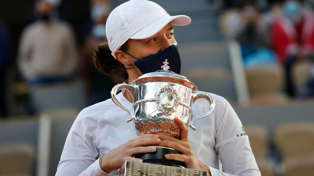 Poland's Iga Swiatek holds the trophy after winning the French Open, beating Sofia Kenin of the US 6-4, 6-1 in the final at Roland Garros, Paris, October 10, 2020.