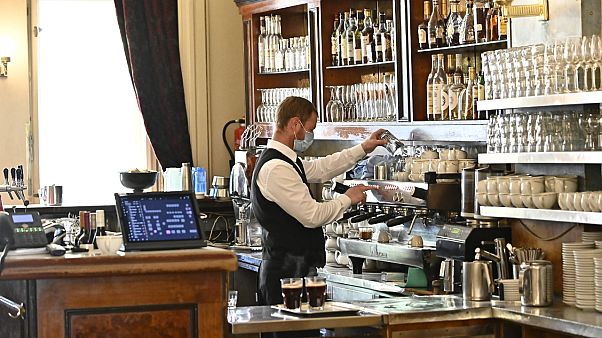 A waiter prepares coffee at cafe Einstein in Berlin, May 15, 2020. A waiter prepares coffee at cafe Einstein in Berlin, May 15, 2020.