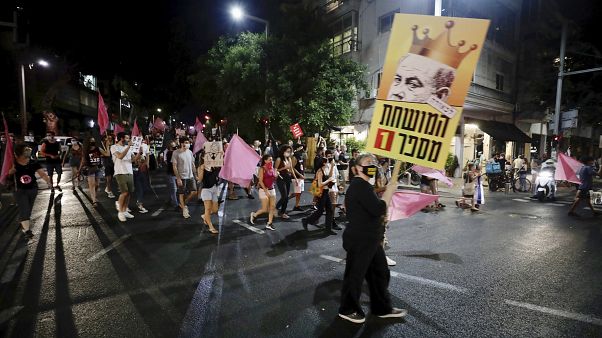 Israeli protesters march on the street during a demonstration against Israeli Prime Minister, Benjamin Netanyahu in Tel Aviv, Israel, Saturday, Oct. 10, 2020. Israeli protesters march on the street during a demonstration against Israeli Prime Minister, Benjamin Netanyahu in Tel Aviv, Israel, Saturday, Oct. 10, 2020.
