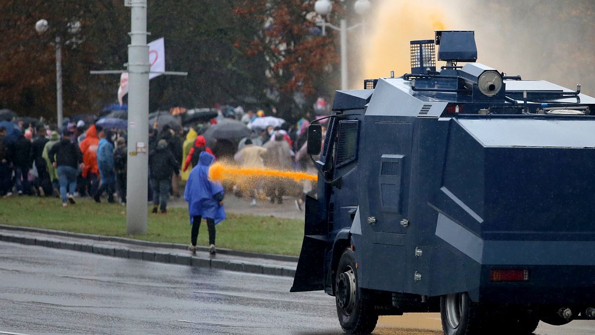 Police use a water cannon truck to disperse demonstrators during a rally to protest against the Belarus presidential election results in Minsk on October 11, 2020.