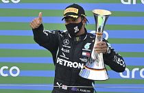 Mercedes driver Lewis Hamilton of Britain holds the trophy after winning the Eifel Formula One Grand Prix in Nuerburg, Germany, Sunday, Oct. 11, 2020.