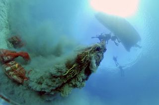 Divers lifting a ghost net in Artatore bay on Lošinj, Croatia