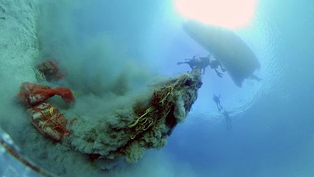 Divers lifting a ghost net in Artatore bay on Lošinj, Croatia